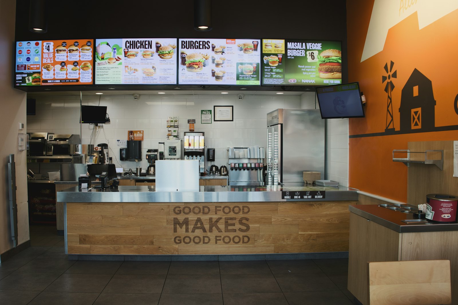 Digital menu boards above a restaurant counter