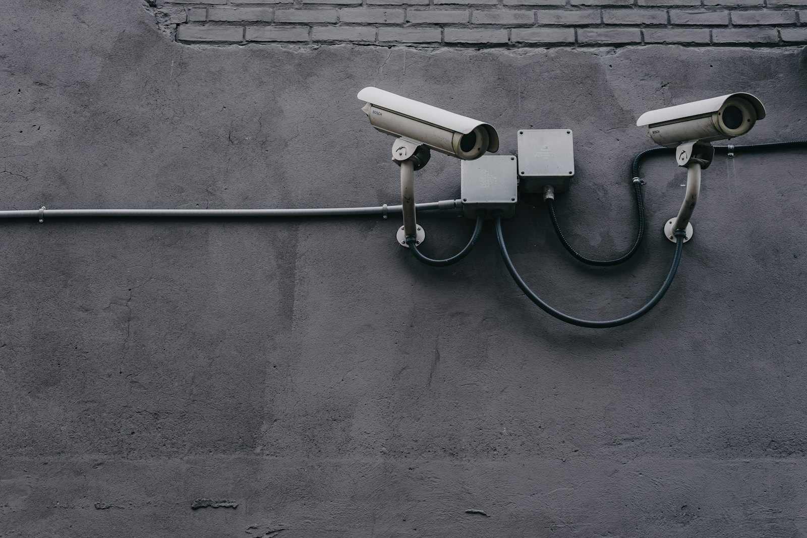 Two security cameras mounted on a wall