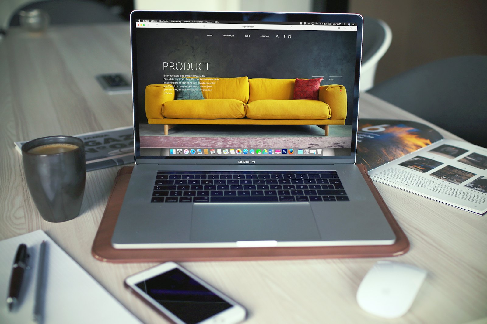 Laptop on a desk showing a website